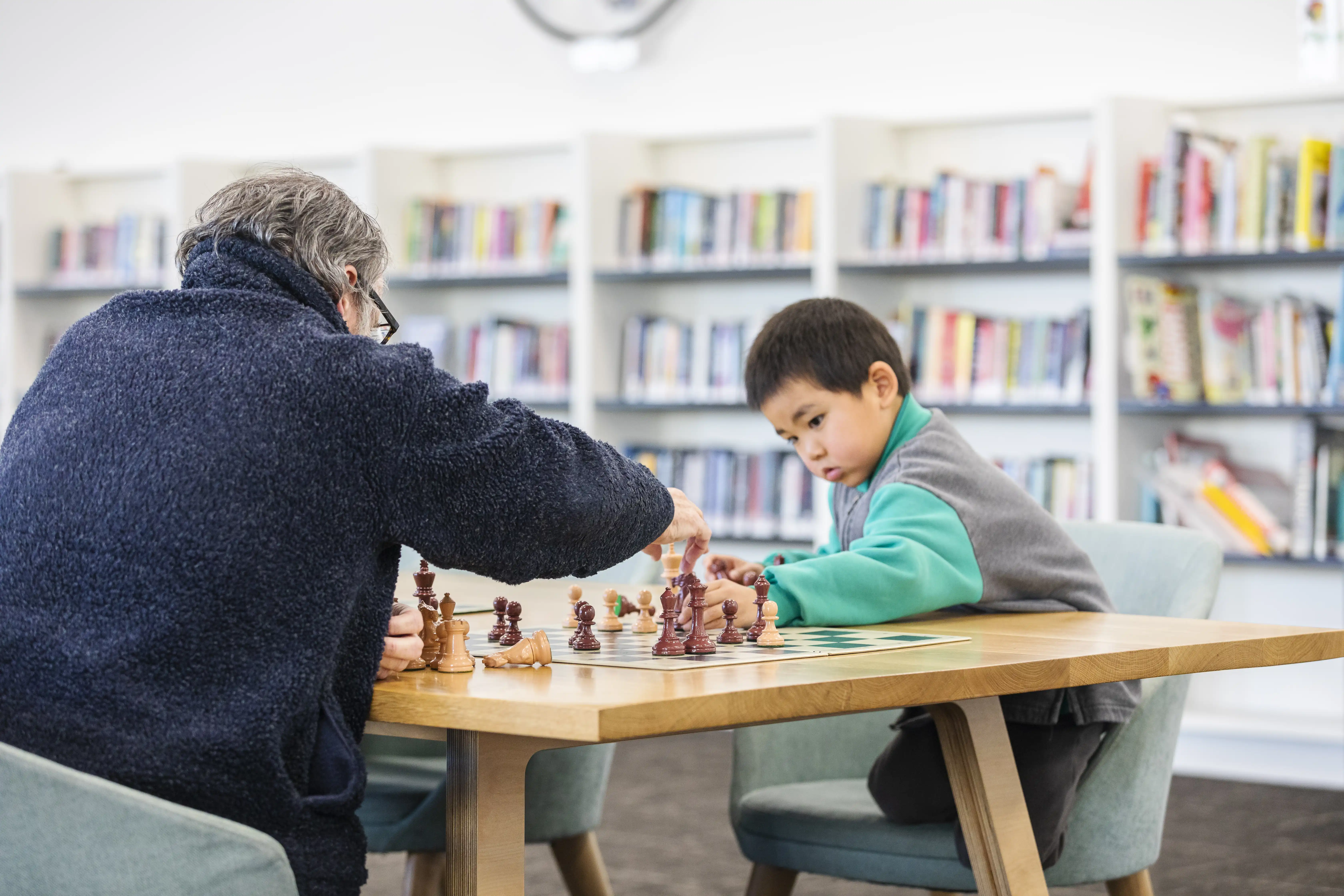 People playing chess at library.